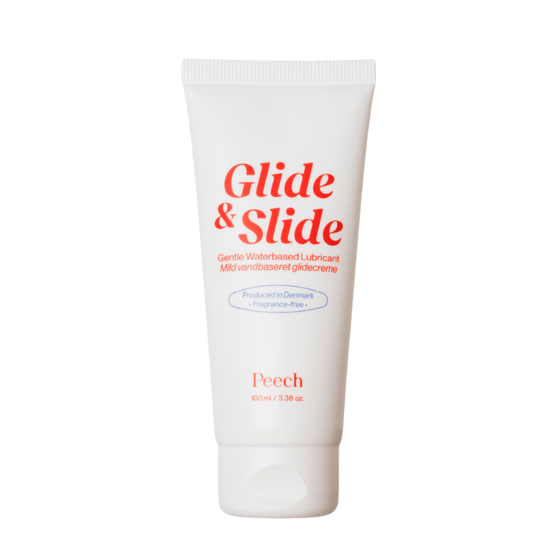 Vit tub med Peech Glide & Slide glidmedel, sett framifrån med röd text
