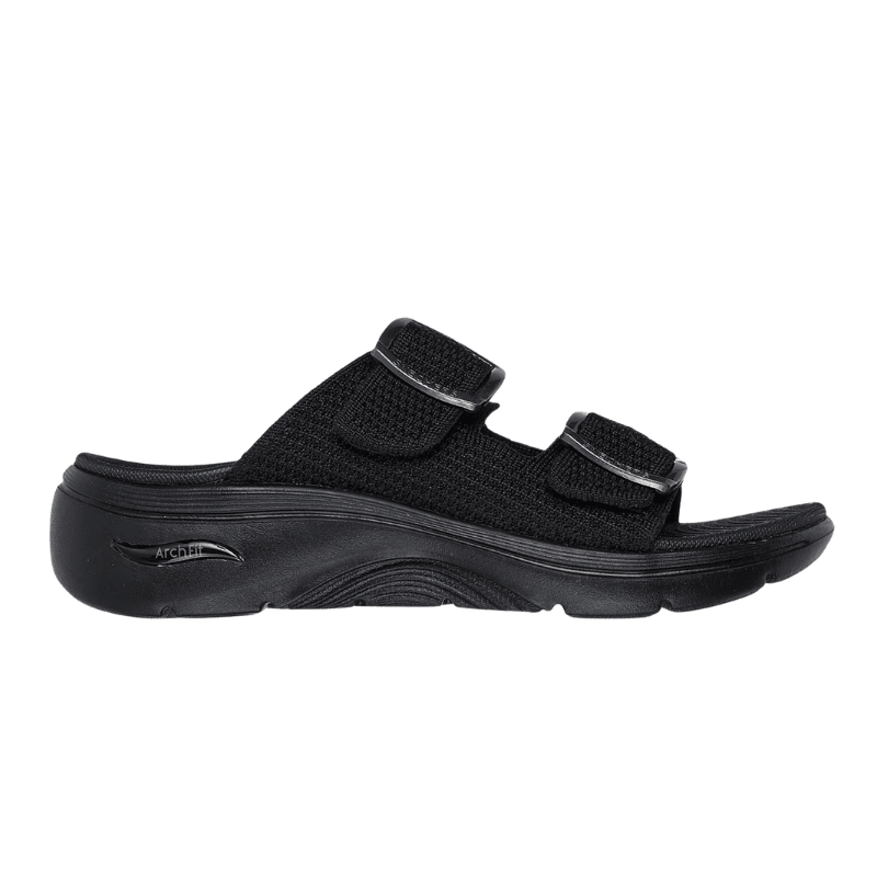 Svart Skechers damtoffel med stickad ovandel och två justerbara remmar, sedd från sidan