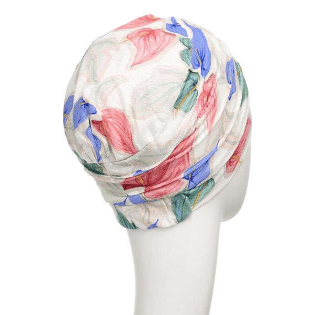 Vit Yoga turban "Tropical blossom" med färgglada blommor på skyltdocka, sedd snett bakifrån