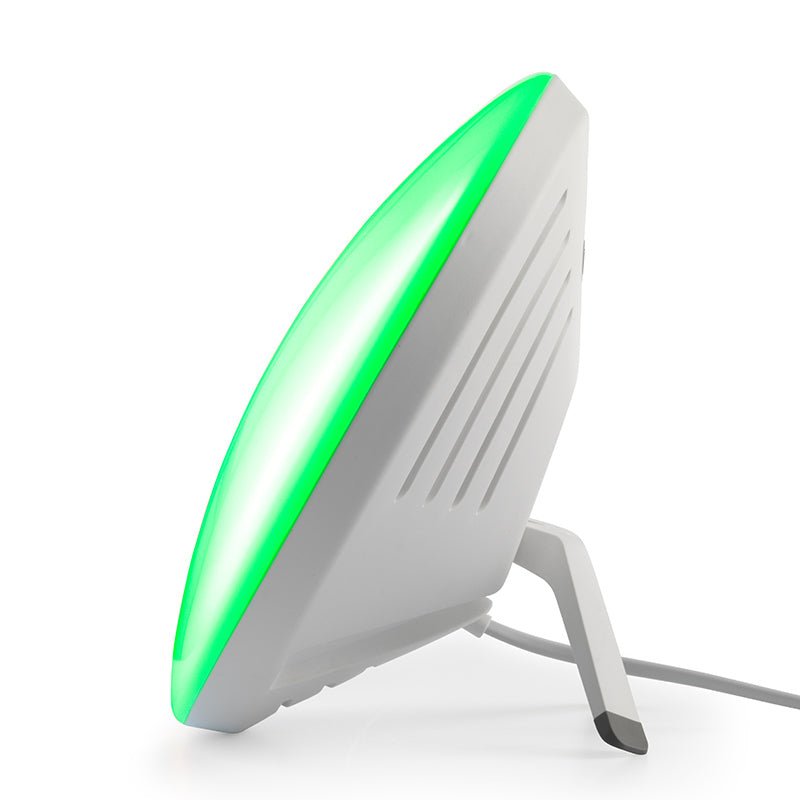 Ljusterapilampa med grönt mood light, sedd från sidan med det grå stativet
