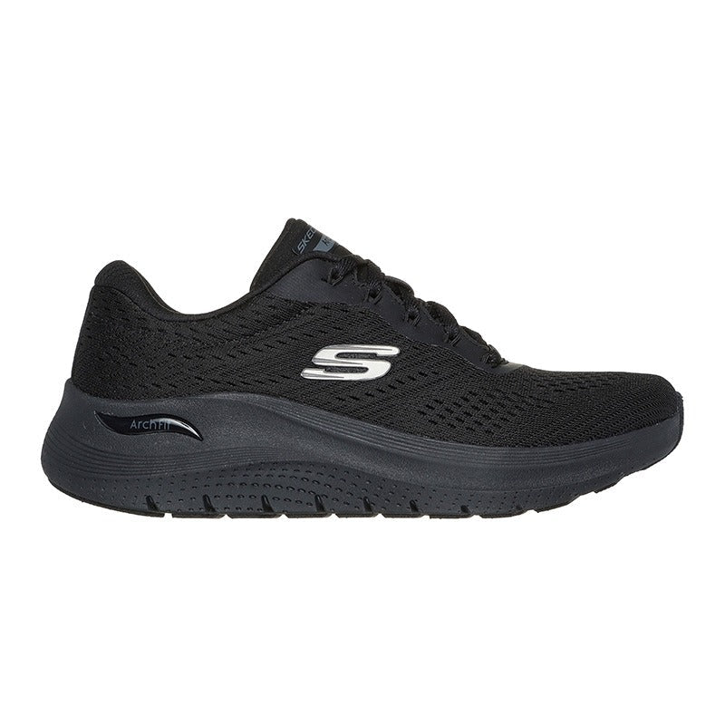Svart Skechers Arch Fit damsneaker från sidan med synlig "S"-logga och "Arch Fit" på sulan