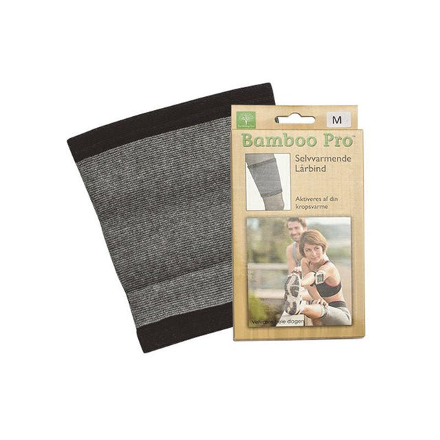 Ett grått bambu lårskydd med svarta ränder, liggande bredvid sin förpackning från Bamboo Pro