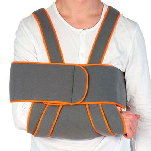 Grå Duo Plus mitella med orange kantband, buren av en person som avlastar armen mot kroppen