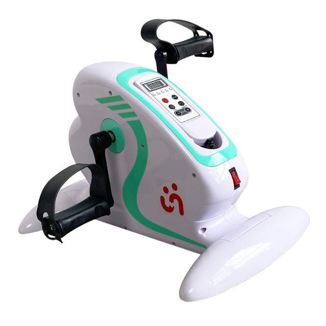 Vit elektrisk pedaltränare med hjälpmotor, grön dekor, display och svarta pedaler, sedd framifrån