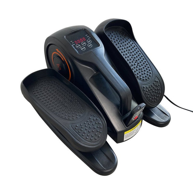 Elektrisk pedaltränare i svart med digital display och texturerade fotpedaler, sedd uppifrån
