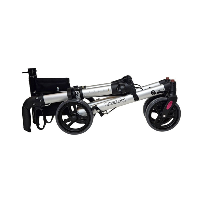 Helt hopfälld aluminiumrollator sedd från sidan, med nedfällda handtag för enkel transport