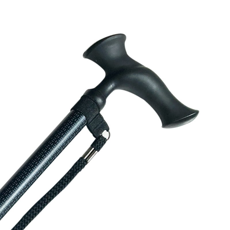 Närbild på den gråmönstrade anatomiska käppens svarta ergonomiska handtag och handledsrem