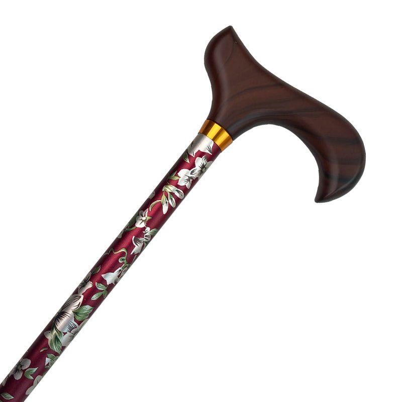 Käpp med blommönster i bordeaux, grått och vitt, med ett mörkt träfärgat handtag och guldfärgad ring