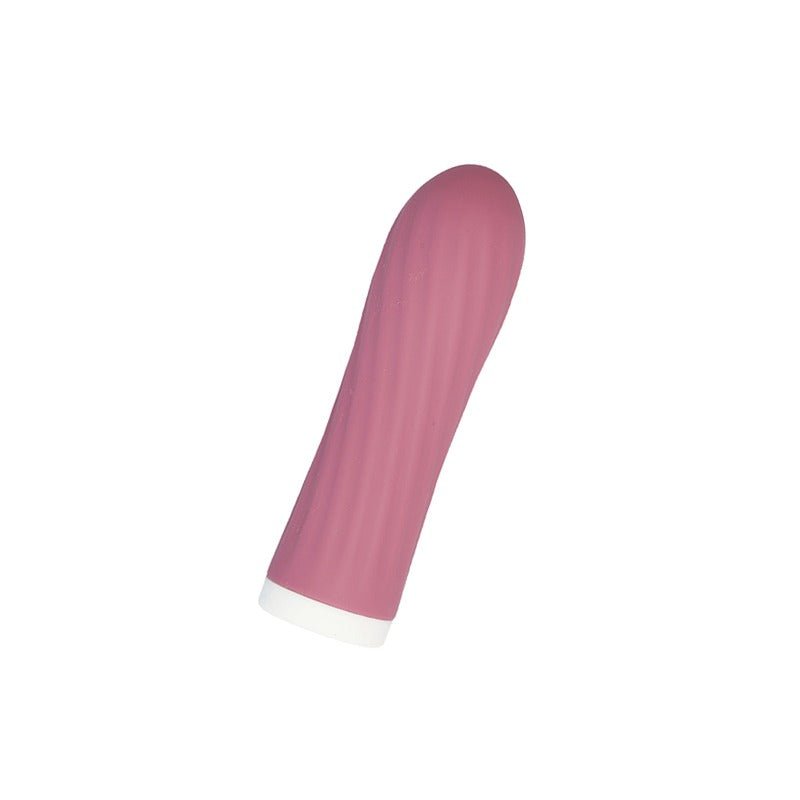 Rosa Bullie vibrator med räfflad yta och vit bas, fotograferad snett uppifrån