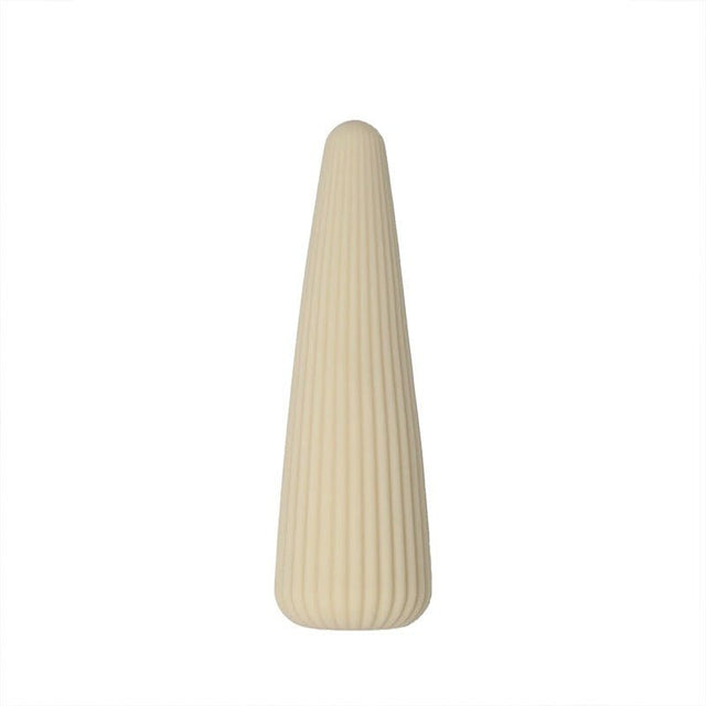 En beige konformad Corny vibrator med räfflade sidor, fotograferad rakt framifrån