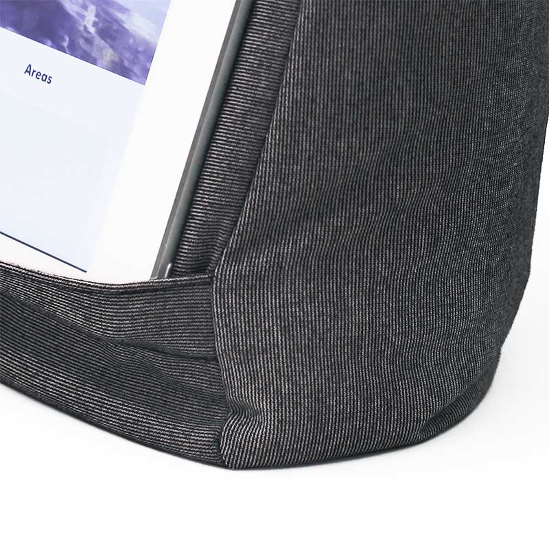 Tæt på den grå 2-i-1 iPad-holder, der viser stoffets tekstur og hvordan en tablet sidder fast