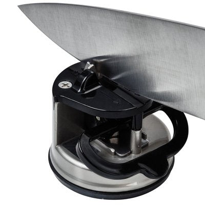 Närbild av en stor kökskniv som slipas i den kompakta AnySharp PRO knivslipen