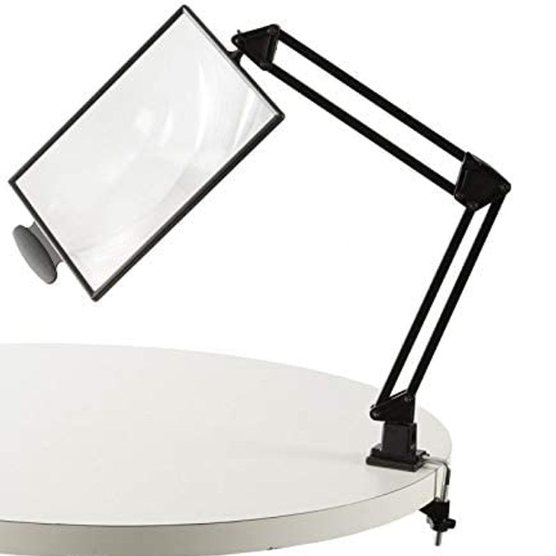 Svart bordslupp med flexibel arm fäst med en klämma på kanten av ett vitt runt bord