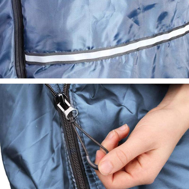 Närbild på åkpåsens dragkedja och reflexband, en hand håller i dragkedjans handtag