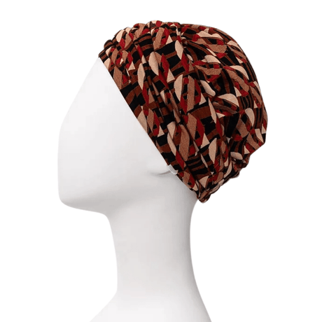 Sapphire Boho turban i Tribal Art-mönster med bruna och röda toner, visad från höger sida på skyltdocka