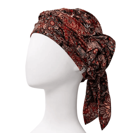 Juvela turban Floral Folklore på vit mannekäng, sedd snett framifrån med knutet hårband