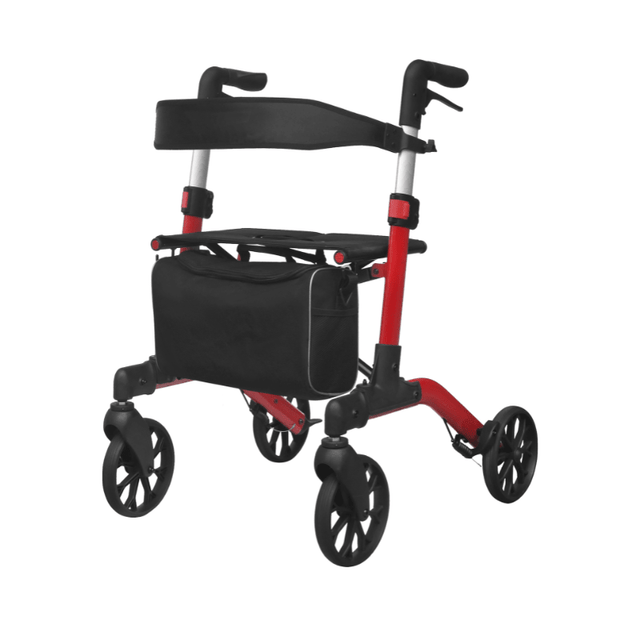 Röd Mambo rollator med svart avtagbar väska under sitsen, sedd snett framifrån