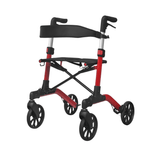 Röd Mambo rollator sedd snett framifrån, med svart sits och synlig ram utan väska