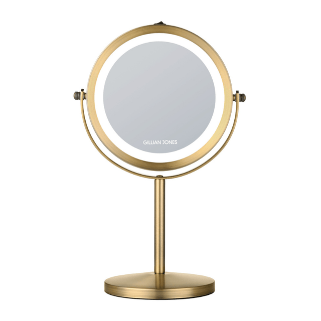 Rundt makeup-spejl med LED-lys i gylden finish, set forfra med Gillian Jones logo